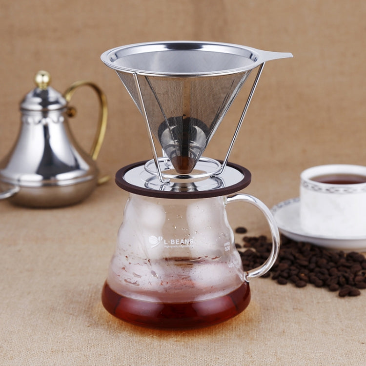 Stainless steel cone filter cup over coffee carafe with round drip base.