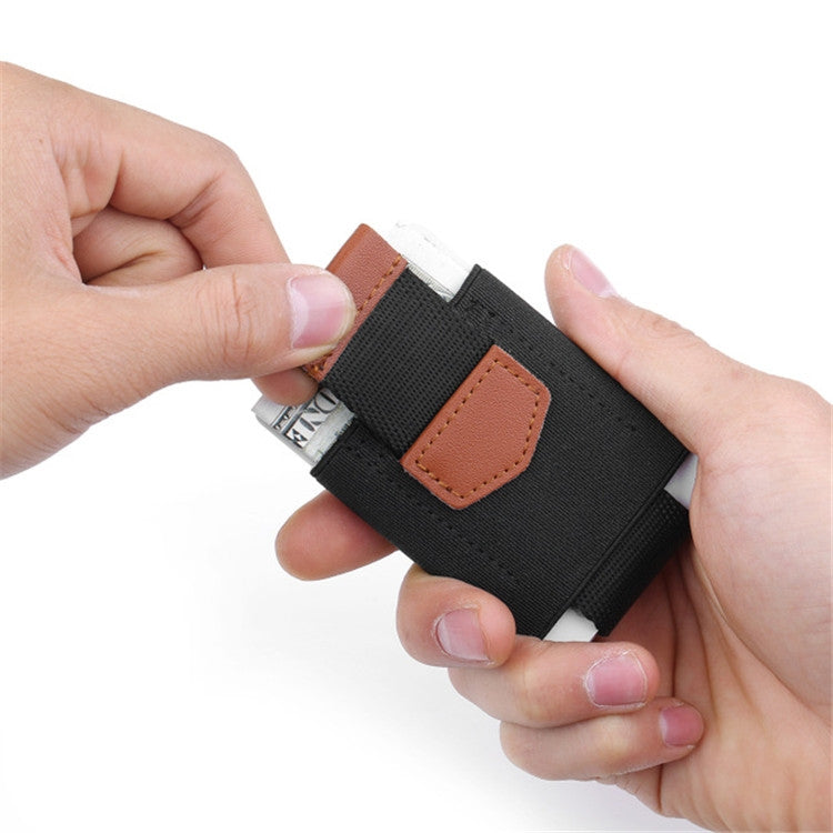 Hands holding black elastic card holder with brown leather tab and card partly out