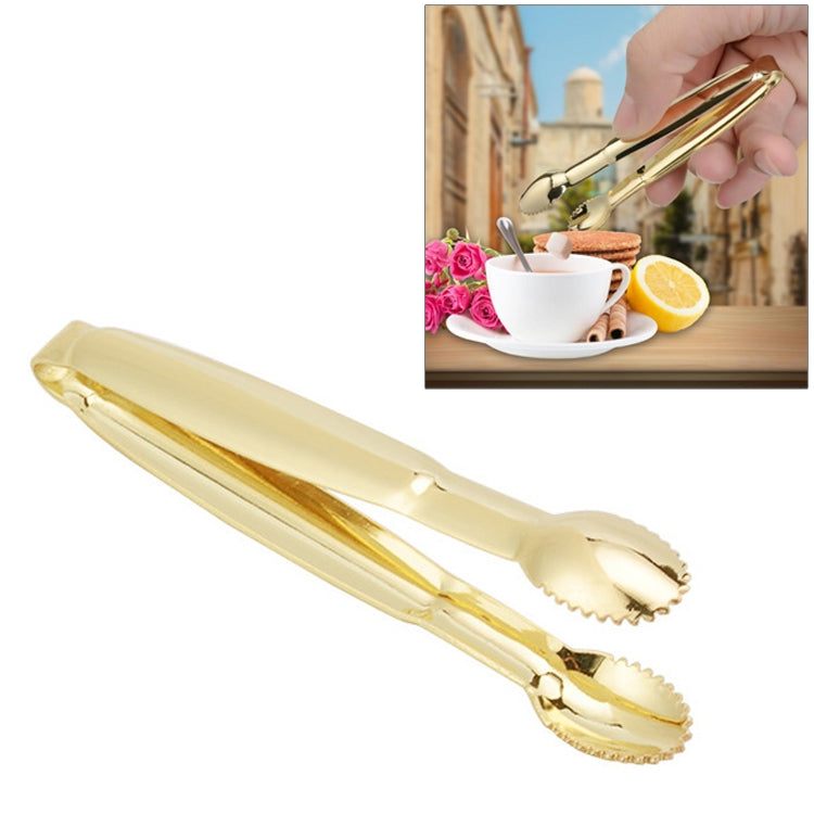 Gold stainless steel sugar clip with serrated ends, holding a sugar cube
