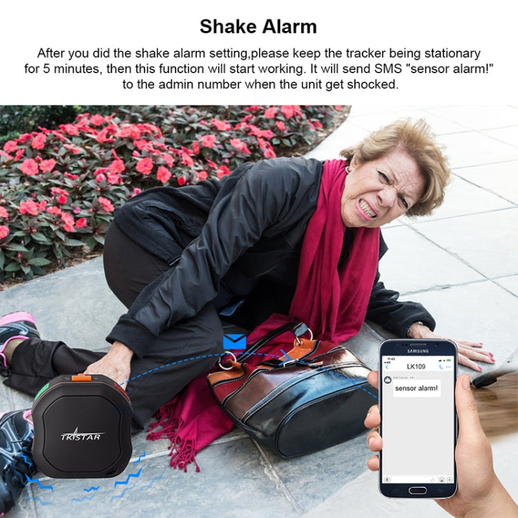 Black GPS tracker with shake alarm shown on ground beside smartphone app