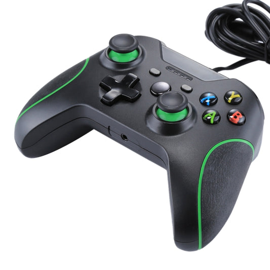 Black wired game controller with green trim, top view with D-pad, sticks, and triggers