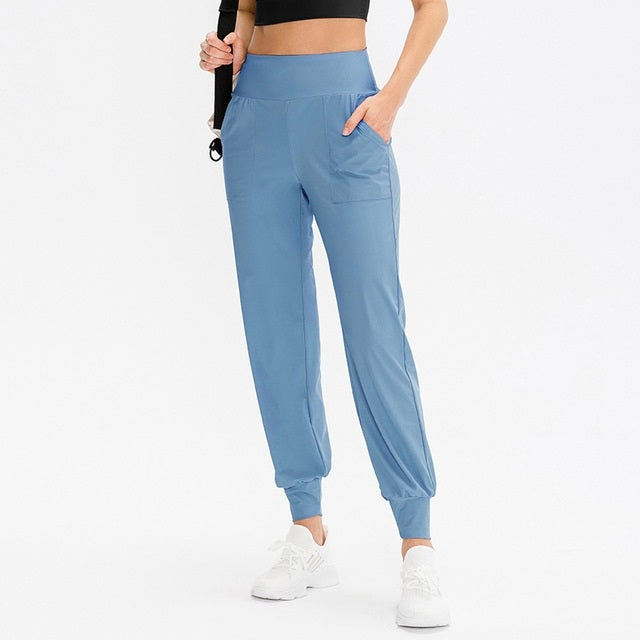 Women’s loose sports trousers, dusty blue, elastic waistband, side pockets, tapered cuffs