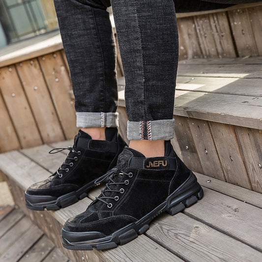 Black high-top lace-up safety work shoes with cushioned rubber soles, on feet