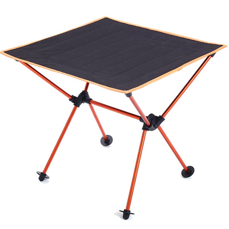 Folding picnic table with dark fabric top and orange metal legs, corner straps
