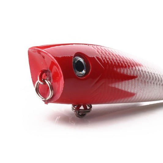 Close-up of a red hard fishing lure with silver treble hook and round front eye