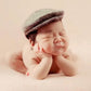 Newborn cabbie hat and bowtie set, beige tweed cap on a sleeping baby
