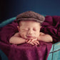 Newborn cabbie hat and bowtie set, brown tweed cap on a sleeping baby