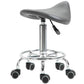 Gray PU saddle stool on chrome base with five rolling casters