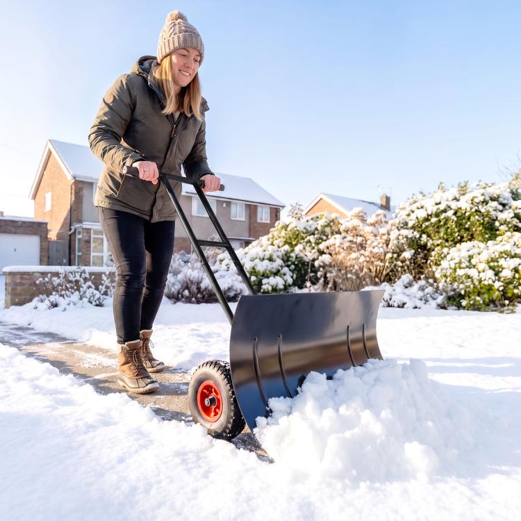 Black wheeled snow shovel with curved metal blade, red wheels, and long handle