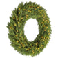 Green artificial Christmas wreath with warm LED lights across the full circular shape.