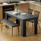 Rectangular dining table with black wood-effect top and four angled legs