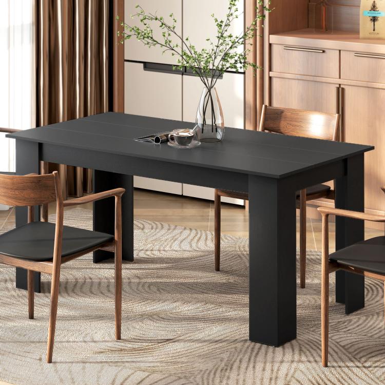 Rectangular dark dining table with matte top and squared legs beside dining chairs
