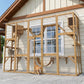 Wooden outdoor cat enclosure with mesh panels, shelves, and rope bridge; cats walking inside.