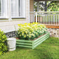 Light green galvanized raised garden bed with yellow flowers and leafy plants