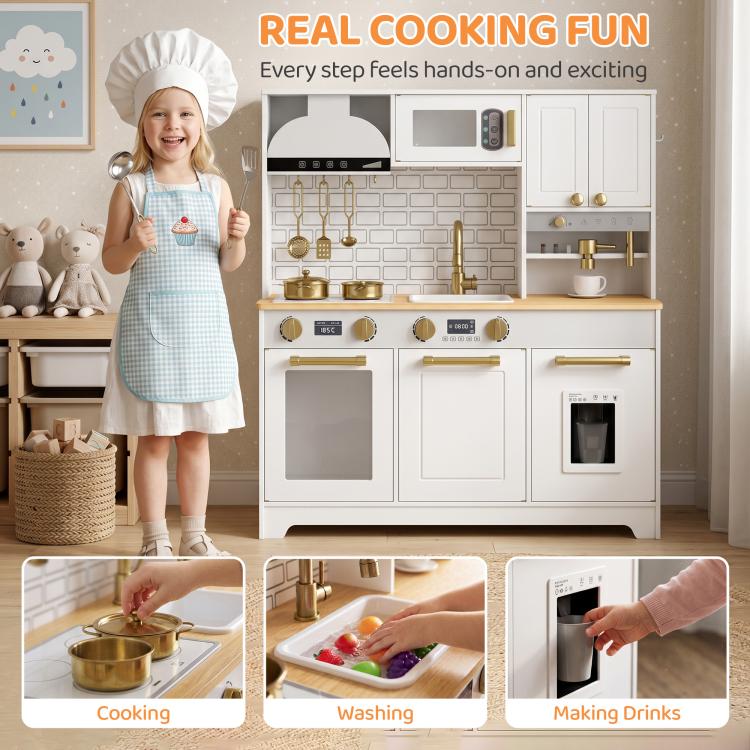 Child in apron standing by white kids play kitchen with gold faucet and stove