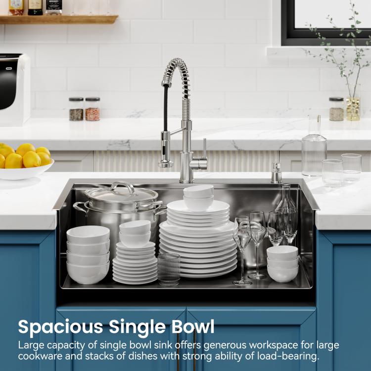 Black single-bowl overmount sink with faucet and stacks of dishes inside