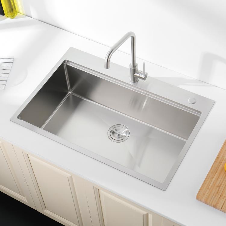 Single-bowl stainless kitchen sink with faucet and deep rectangular basin with drain