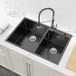 Black double-bowl kitchen sink with faucet holes and two drain openings