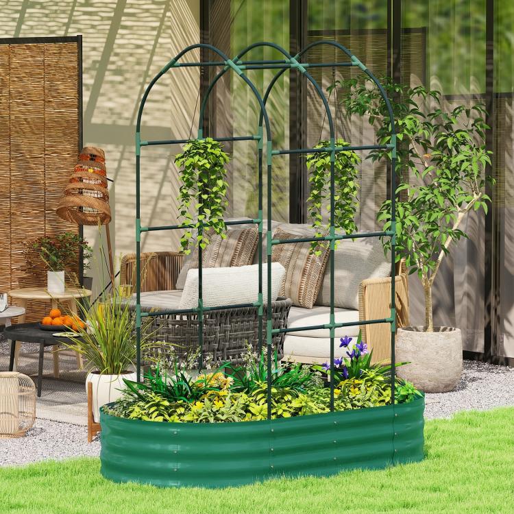 Green metal raised garden bed with arched trellis in outdoor patio with planted greens