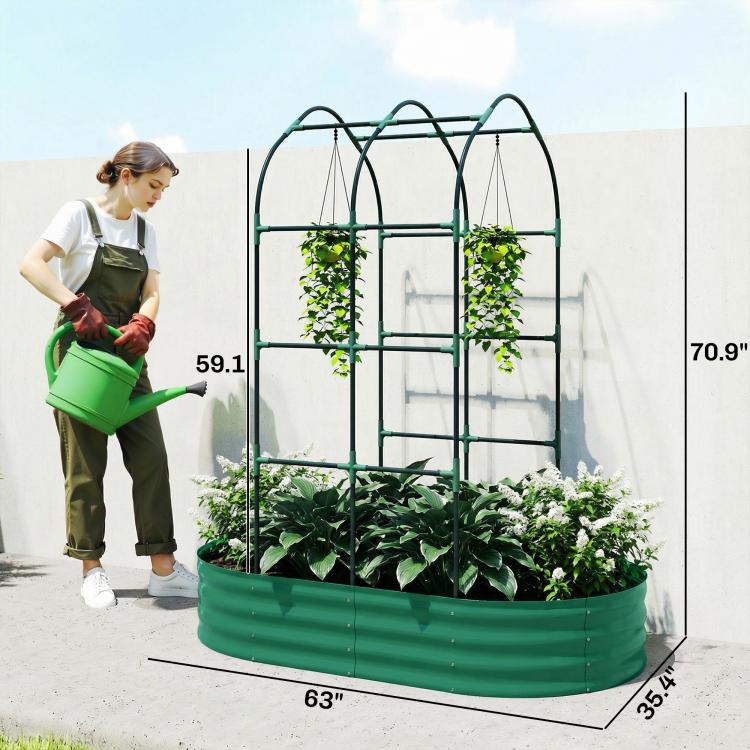 Green metal raised garden bed with arched trellis, person tending plants beside wall