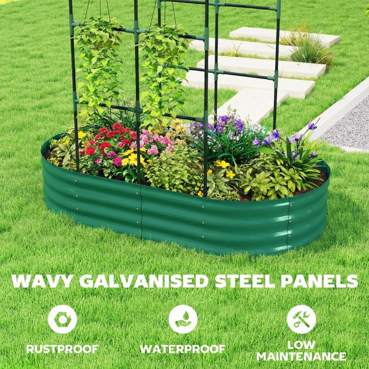 Green metal raised garden bed with arched trellis, colorful flowers and herbs