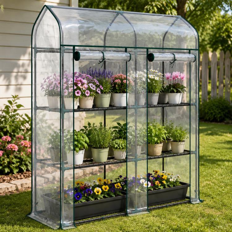 Clear 3-tier mini greenhouse with green frame, roll-up doors, and plant pots on shelves