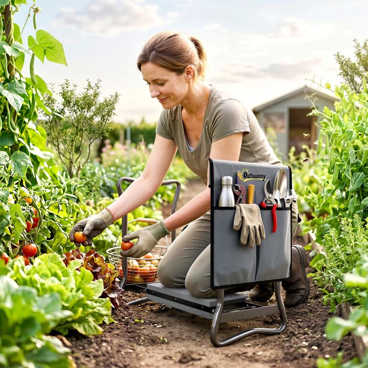 Gray foldable garden kneeler with EVA pad and tool pouch in use by gardener.