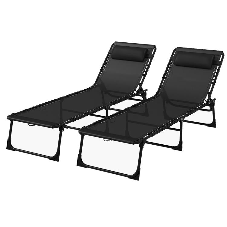 Two black folding poolside chaise lounges with adjustable recline and bungee seat webbing
