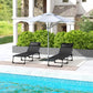 Two black folding chaise lounge chairs with padded headrests for outdoor poolside lounging