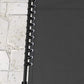 Close-up of black bungee seat cords along a folding chaise lounge frame
