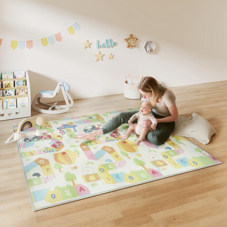 Pastel alphabet and animal reversible play mat laid flat on the floor