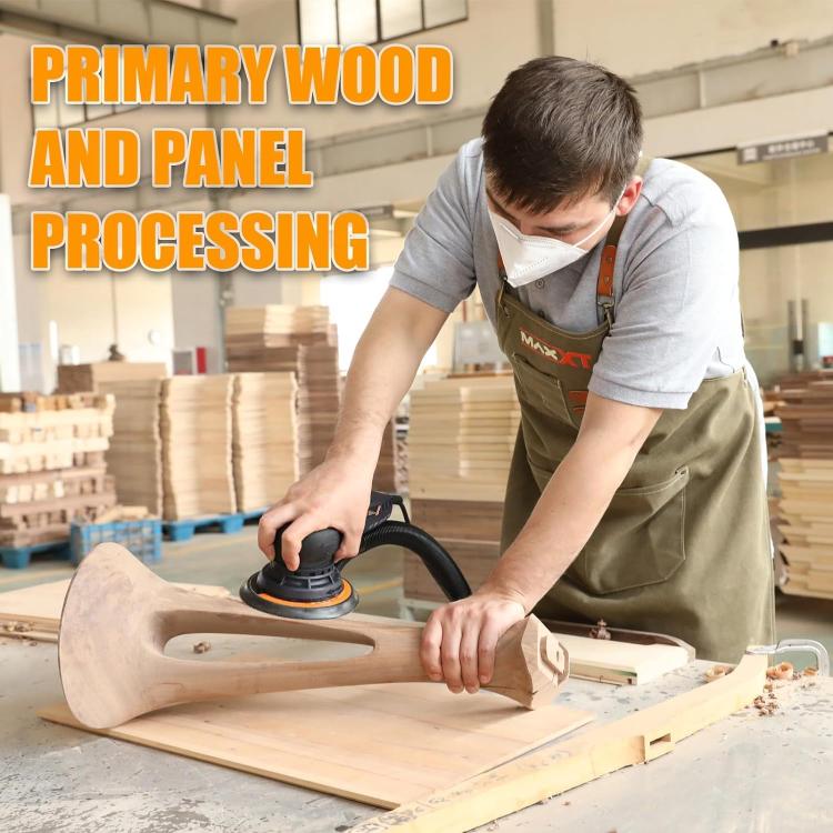 Corded random orbital sander in use smoothing a wood panel