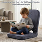 Grey floor chair with tall padded backrest and cushioned seat for kids to read
