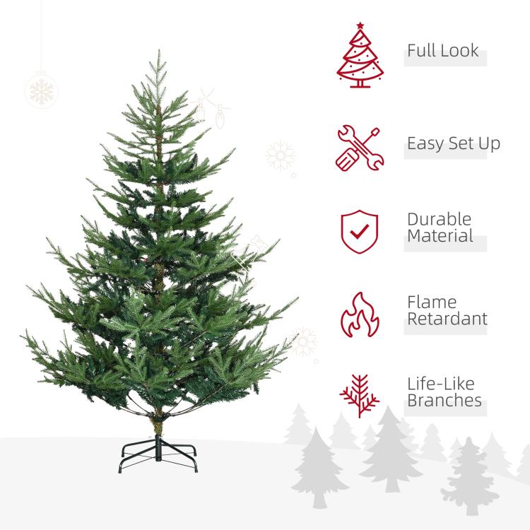 Green artificial Christmas pine tree with full branches on a black metal stand