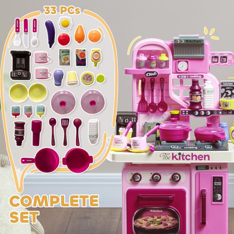 Pink kids play kitchen with 33-piece accessory set displayed around the stove unit