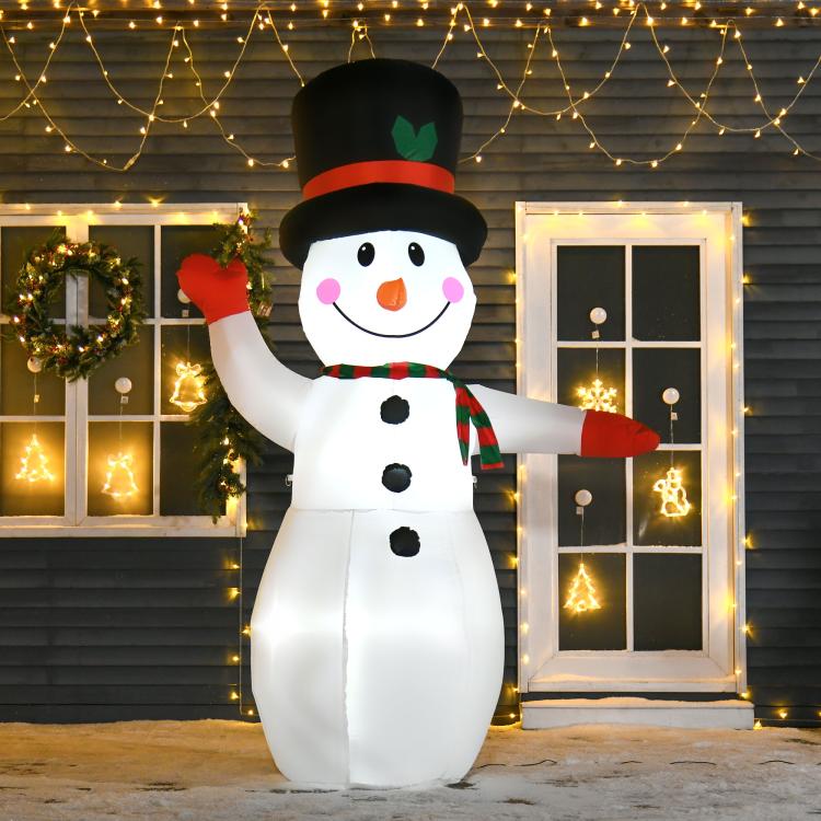Lit inflatable snowman with black top hat, orange nose, green striped scarf, glowing yard decor