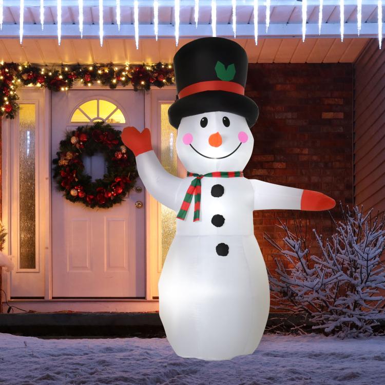 Inflatable snowman with black top hat and orange nose, wearing a green striped scarf