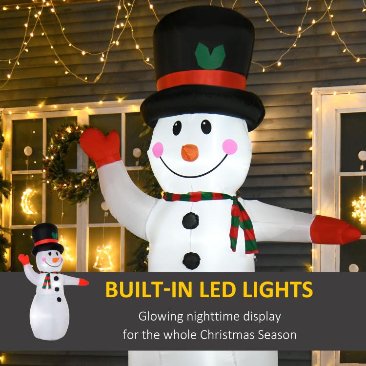 Inflatable snowman with black top hat, orange nose, green striped scarf and built-in LED lights
