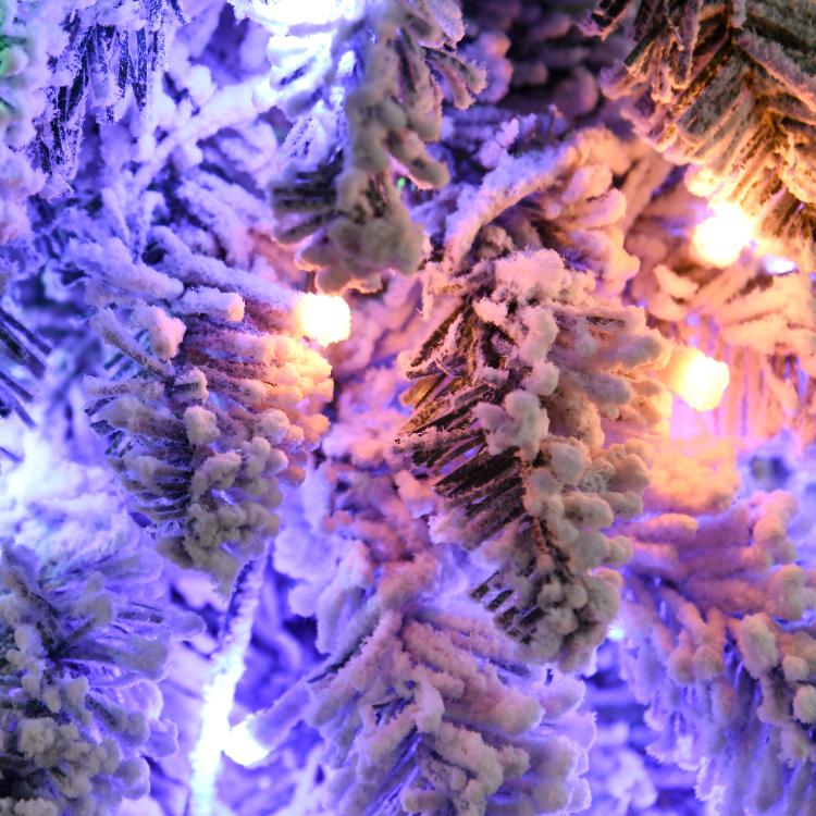 Artificial Christmas tree branches with snow frosting and multicolor LED lights