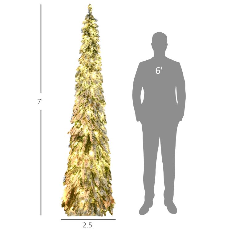 Slim artificial Christmas tree with warm white LED lights beside a person silhouette