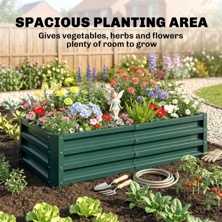 Green metal raised garden bed with slatted sides, planted with mixed flowers in a yard