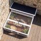 Dark gray wooden tortoise enclosure with open top, wire mesh sides, and clear window