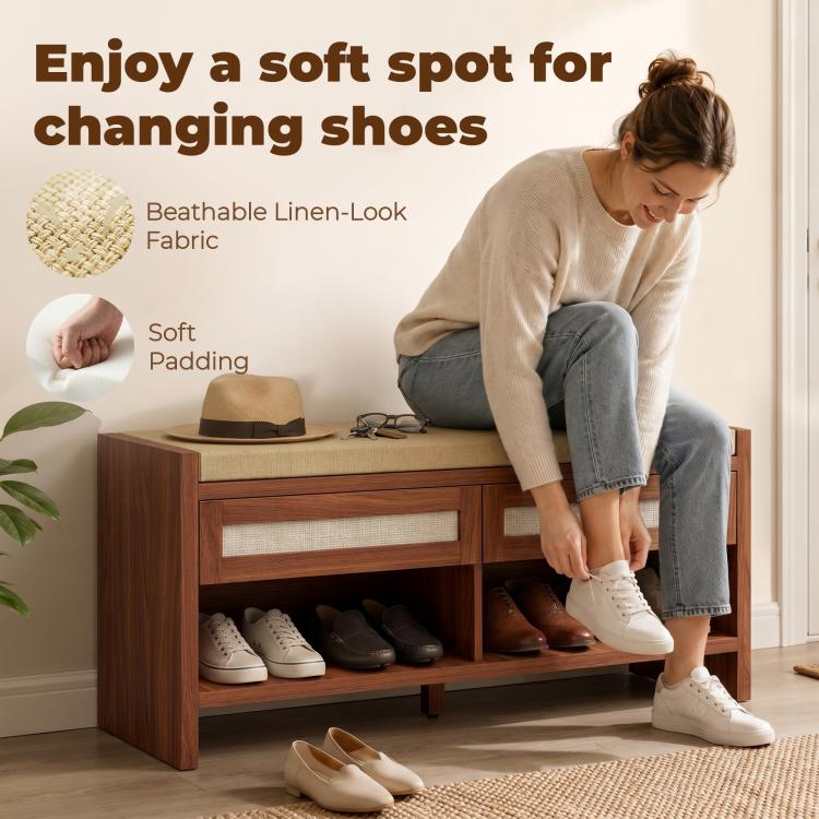 Person placing shoes into a brown shoe storage bench with cushioned seat and open shelf