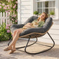 Dark gray cushioned rocking egg chair with woven wicker base and black steel rockers