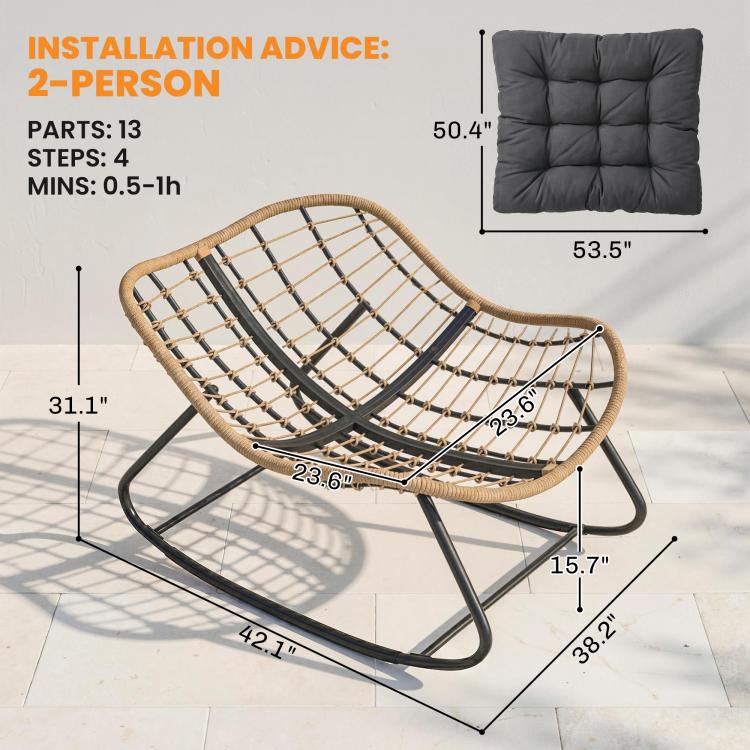 Oversized rocking chair with dark gray cushion, woven wicker frame, and black rockers