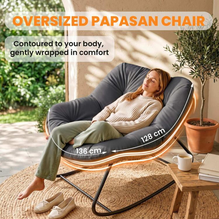 Oversized papasan rocking chair with dark gray cushion and woven wicker underside, black frame