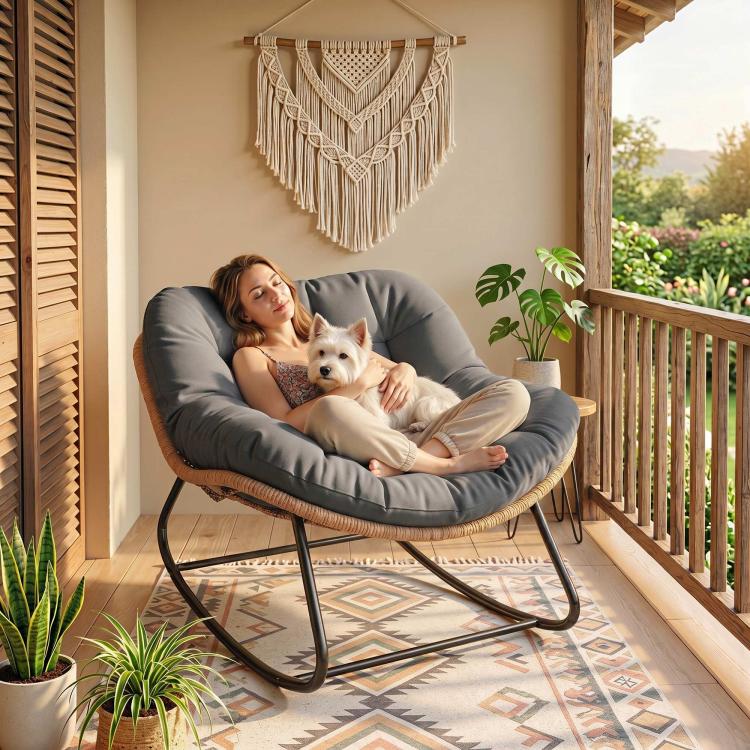 Dark gray cushioned rocking egg chair with woven wicker seat and black metal rockers