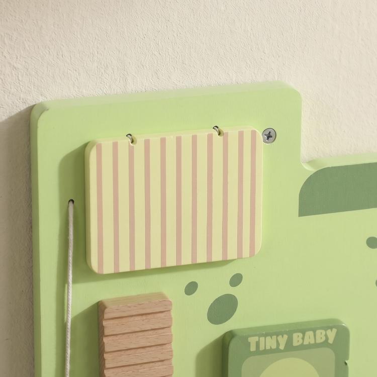 Green dinosaur busy board close-up of wooden slat panel and striped flap window