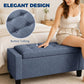 Dark blue-gray button-tufted storage ottoman bench with padded armrests and wooden legs