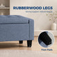 Dark blue-gray storage ottoman with rubberwood legs and protective foot pads